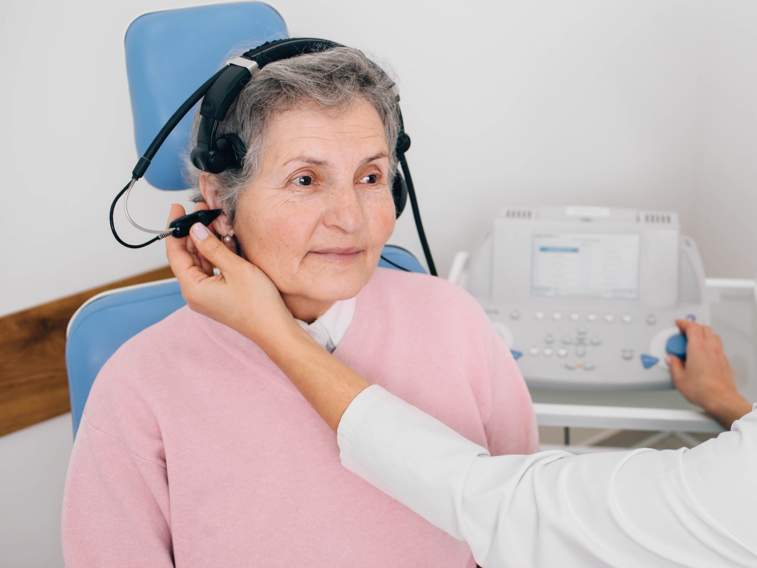 Image Senior woman having hearing exam with special headphones