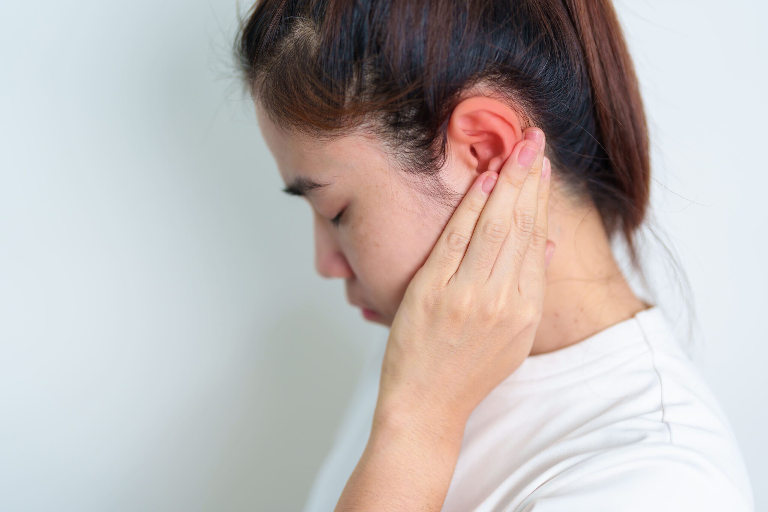 Image woman holding her painful ear ear disease atresi 2025 03 09 08 38 01 utc